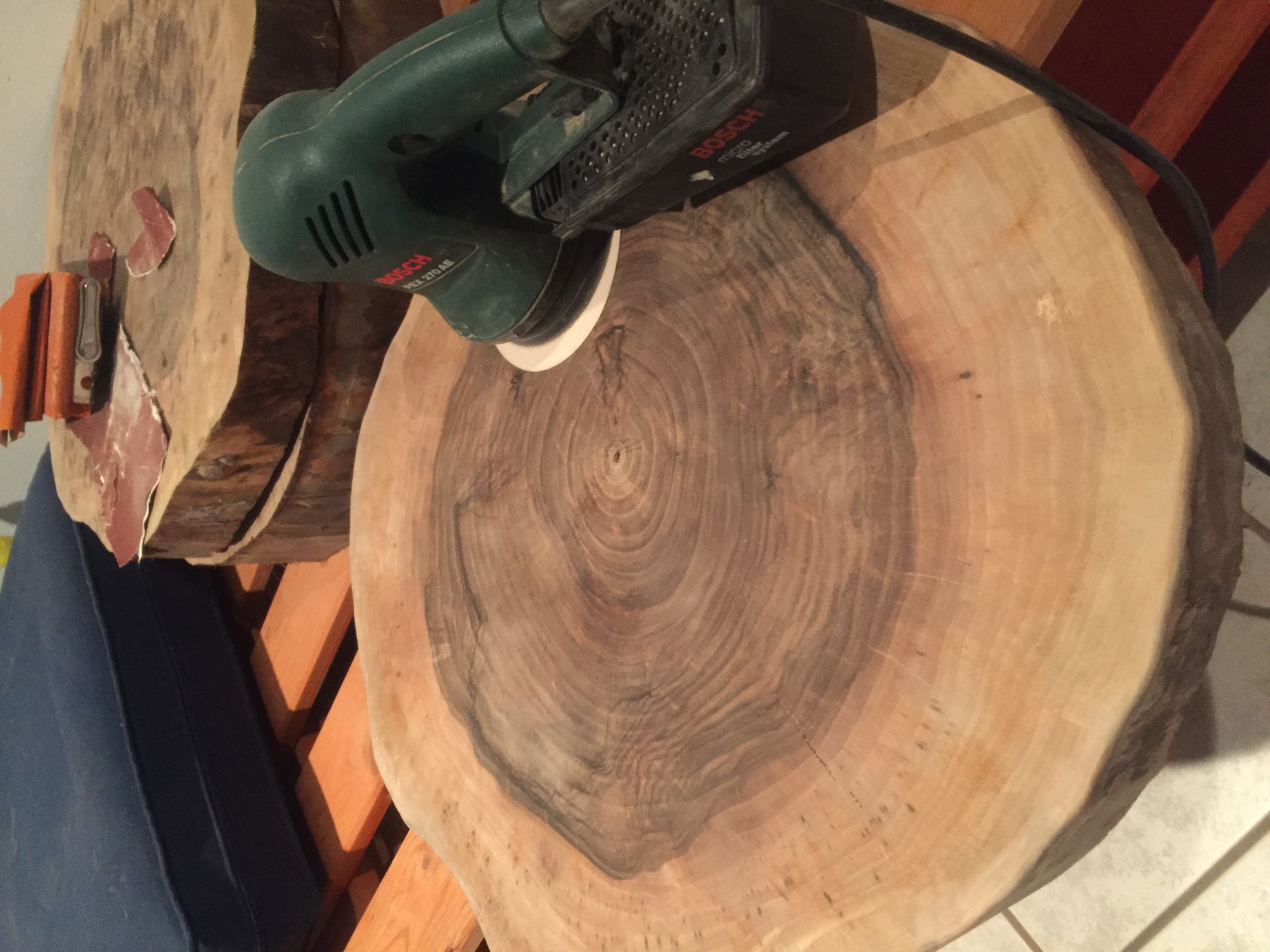 Sanding the walnut slab with a Bosch orbital sander