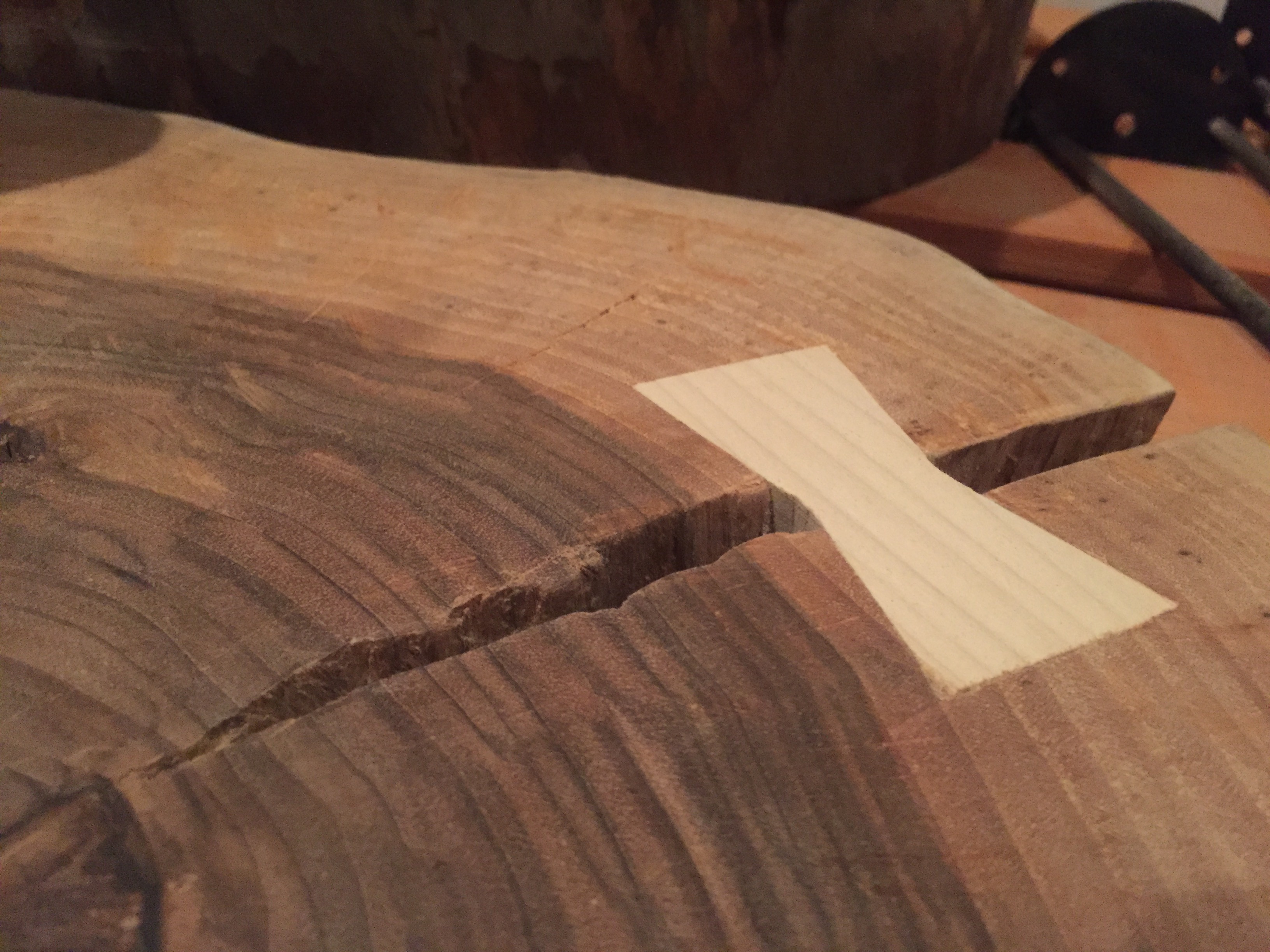 Butterfly bow-tie inlay stabilizing the crack in the table slab